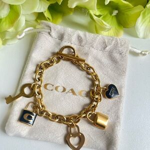 COACH Gold-Tone Charm Bracelet with black and crystal Accents